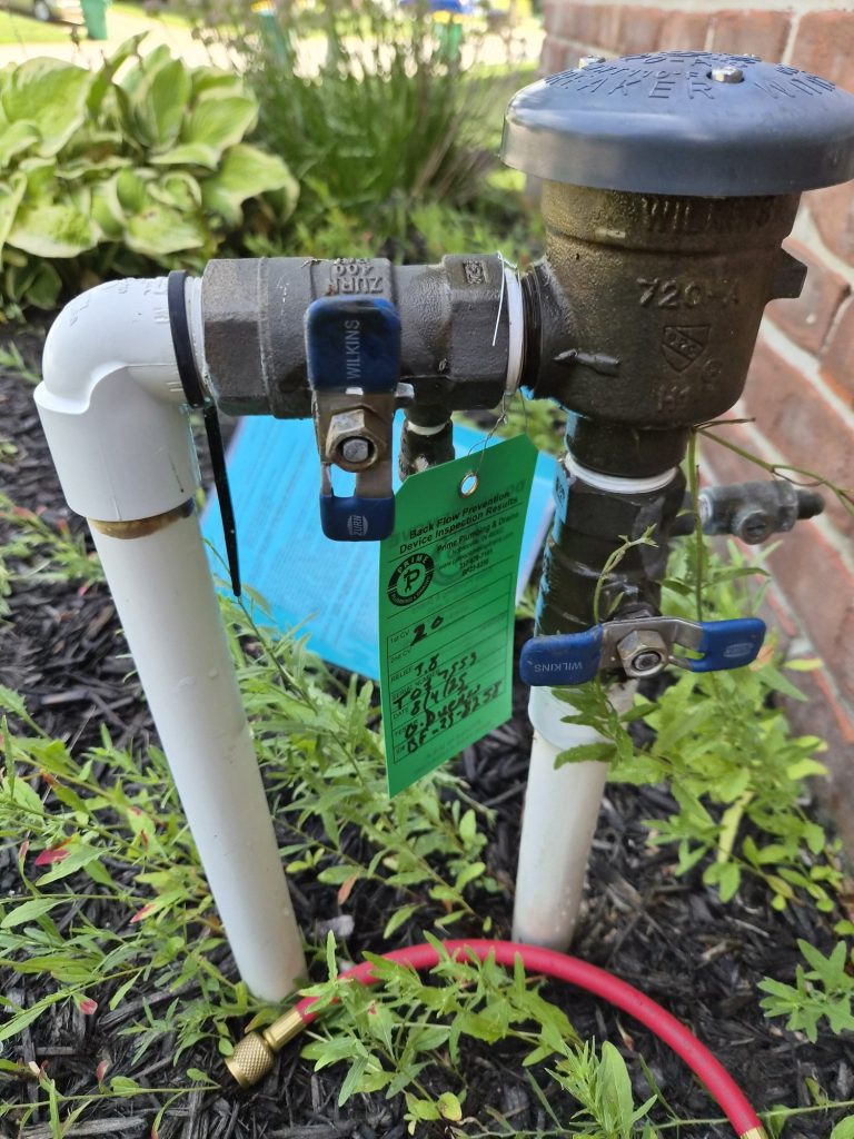 A backflow preventer outdoors, part of an irrigation system.