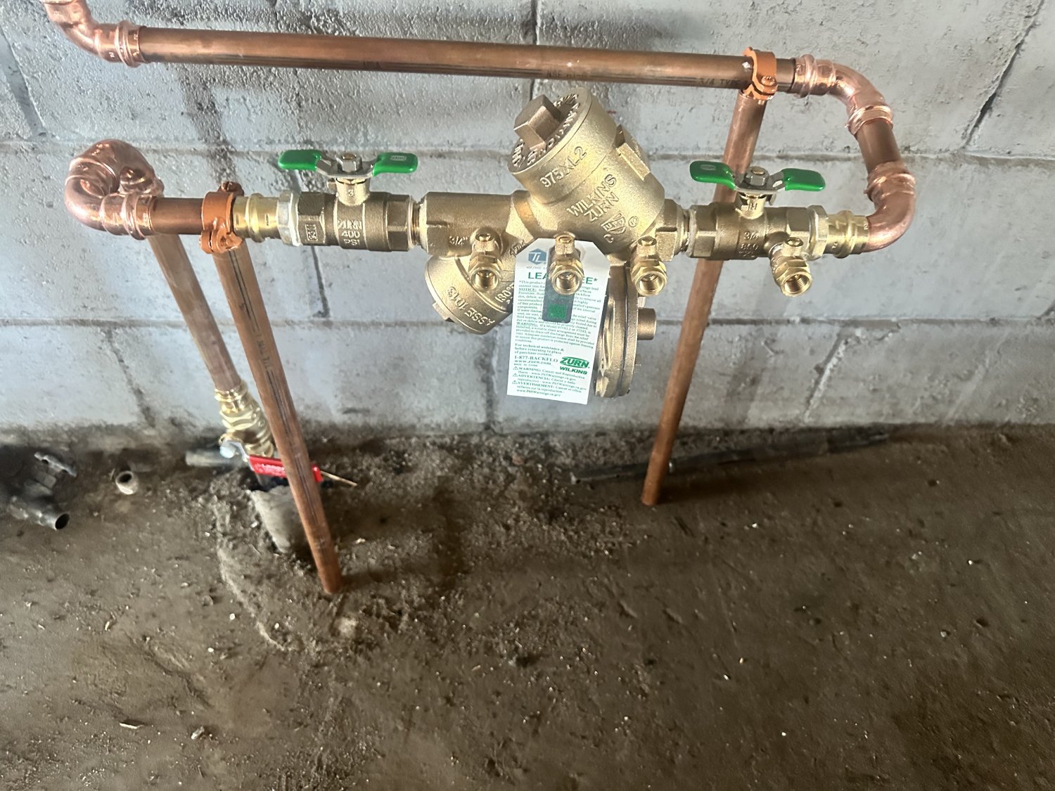 Copper pipes with commercial backflow preventer.