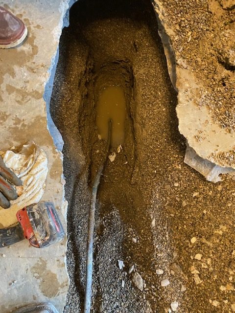 Exposed underground water line leak under a slab