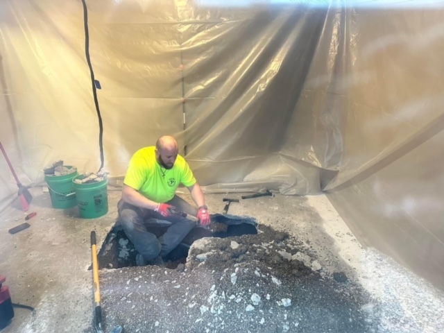 Plumber repairing an under-slab water line