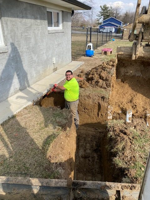 Prime Plumber working in a trench