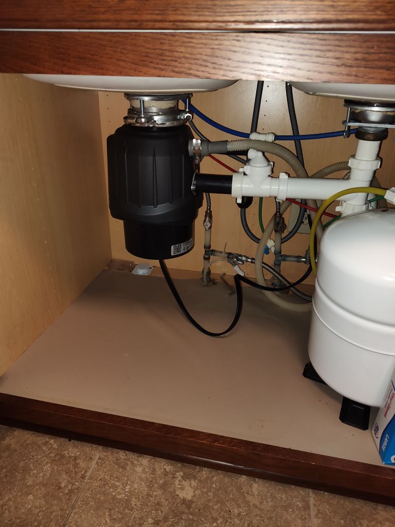 Recently installed black garbage disposal.