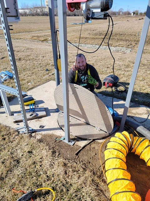 Technician performing industrial sewer maintenance.