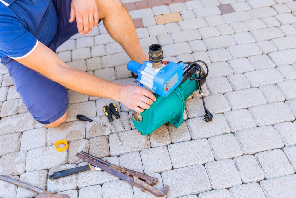Plumber repairing a well pump