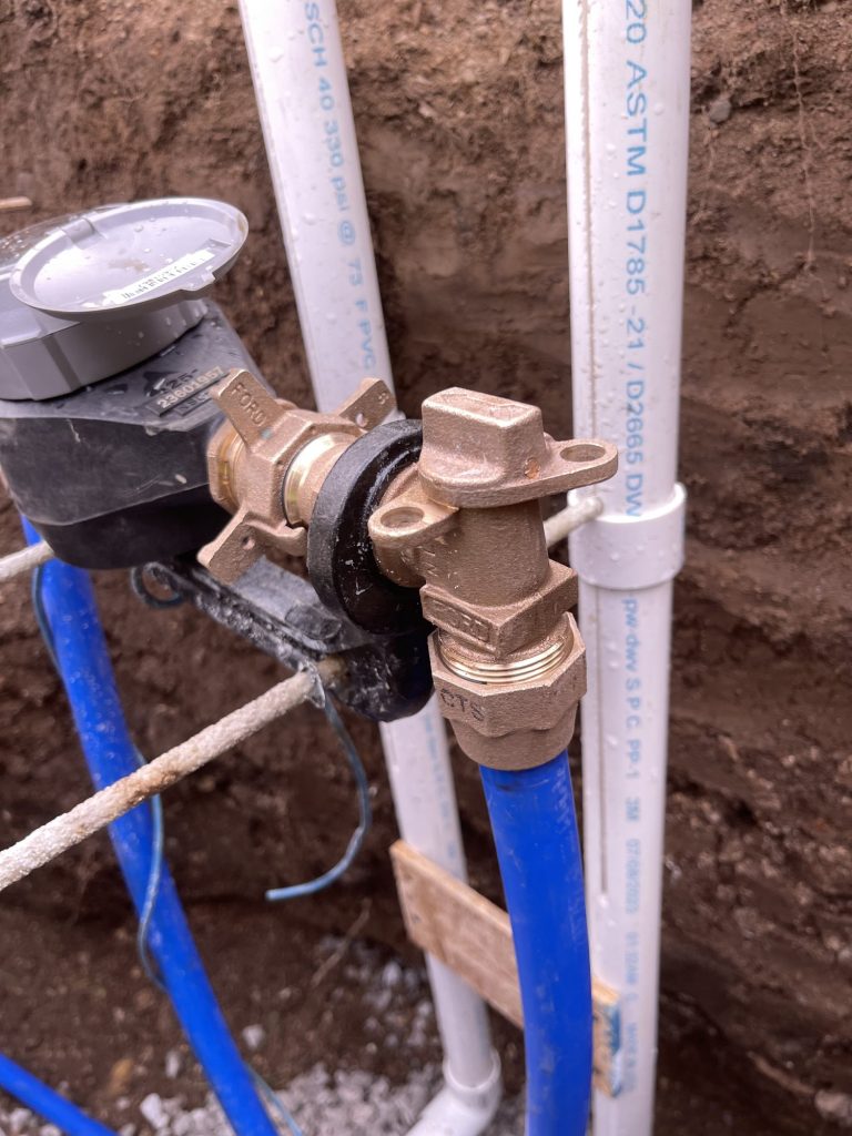 Recently installed water meter with blue PEX pipes.) (NOTE: place horizontally
