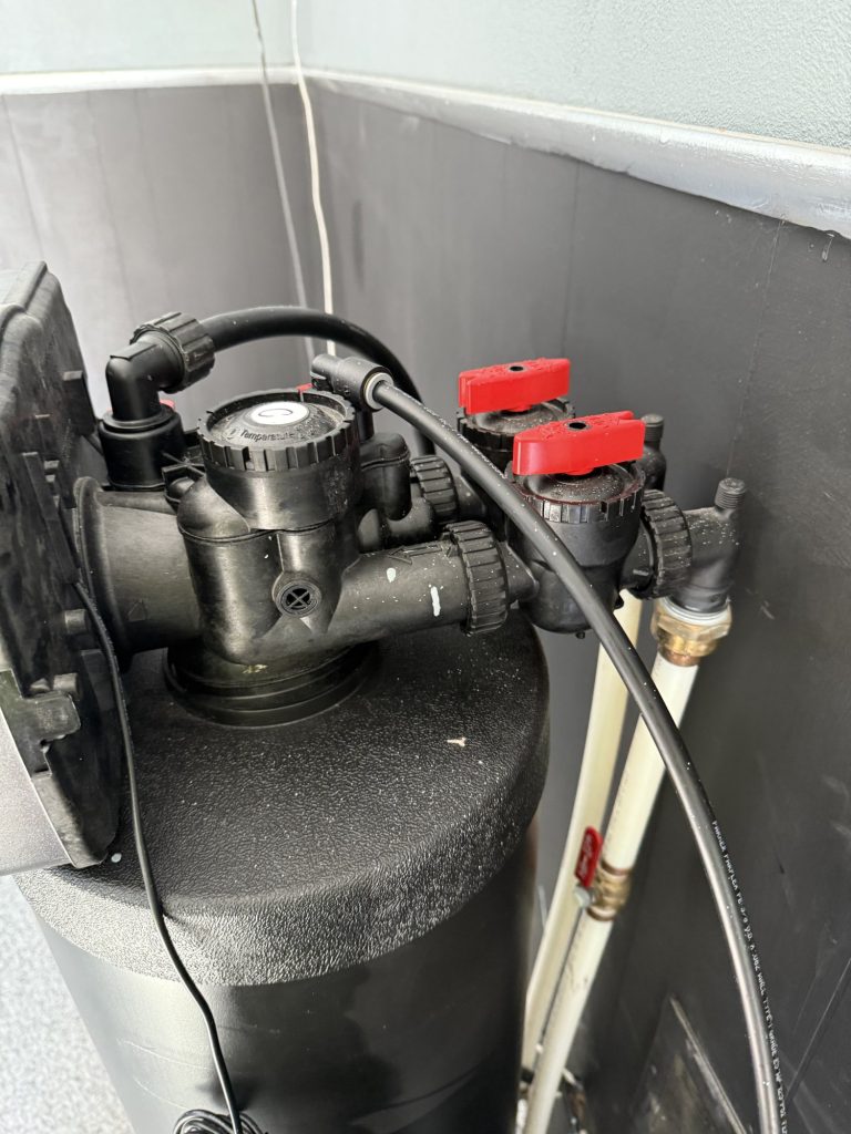 Closeup of water softener setup and connections
