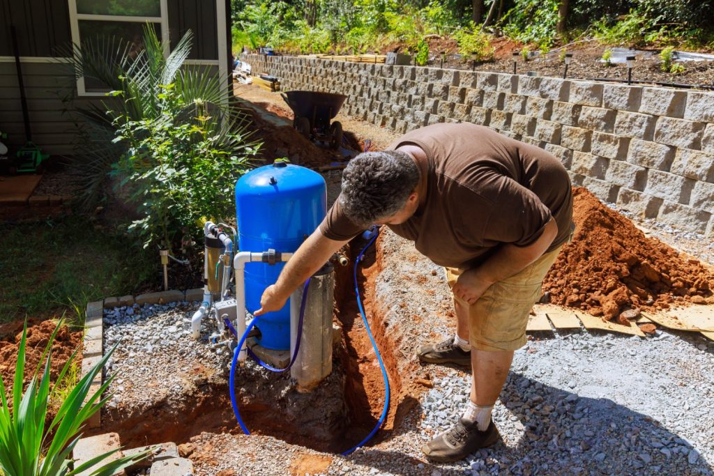 Plumber checking well pump installation