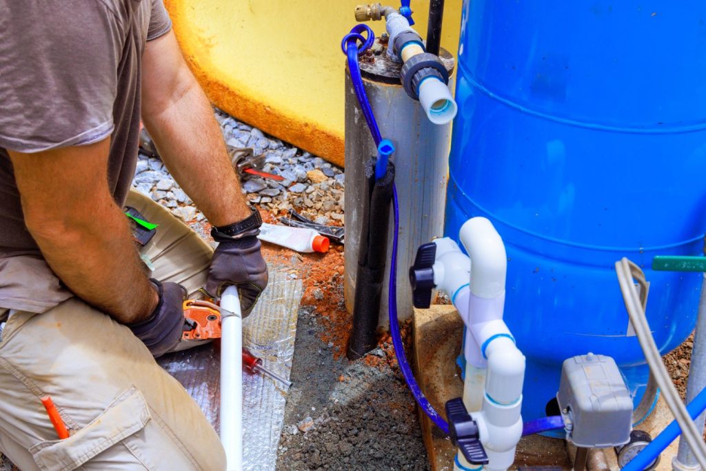 Plumber repairing well pump