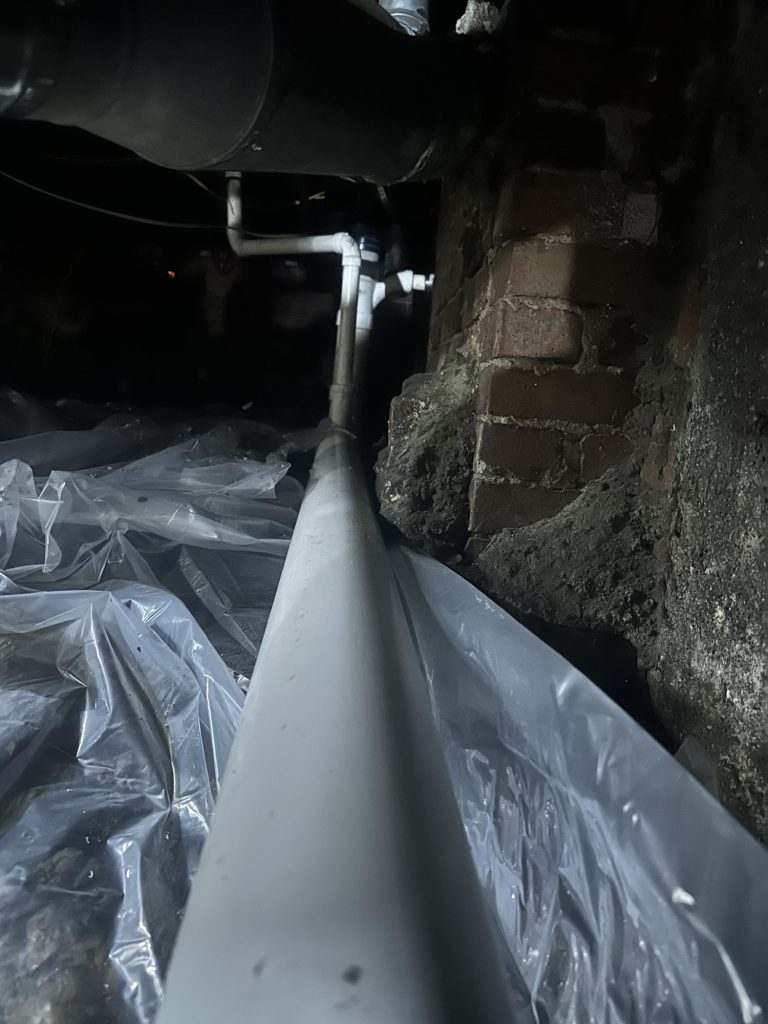 A long white pipe part of a repiping project.
